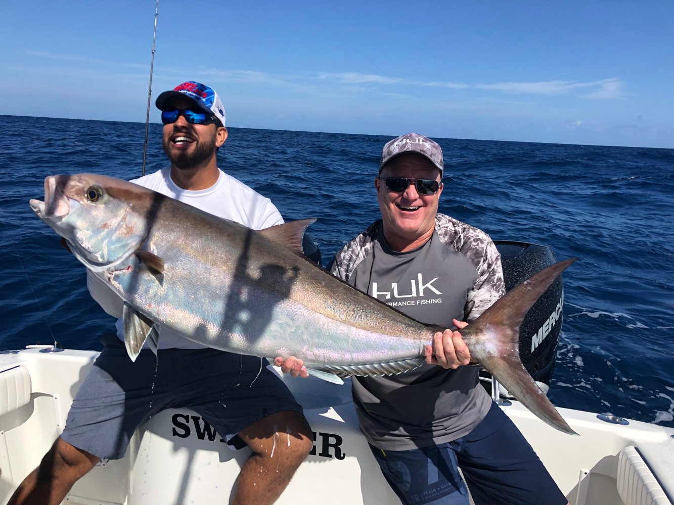 a man holding a fish in the water