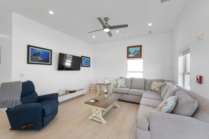 a living room filled with furniture and a tv