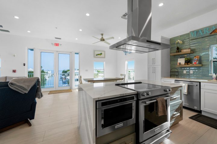a stove top oven sitting inside of a kitchen
